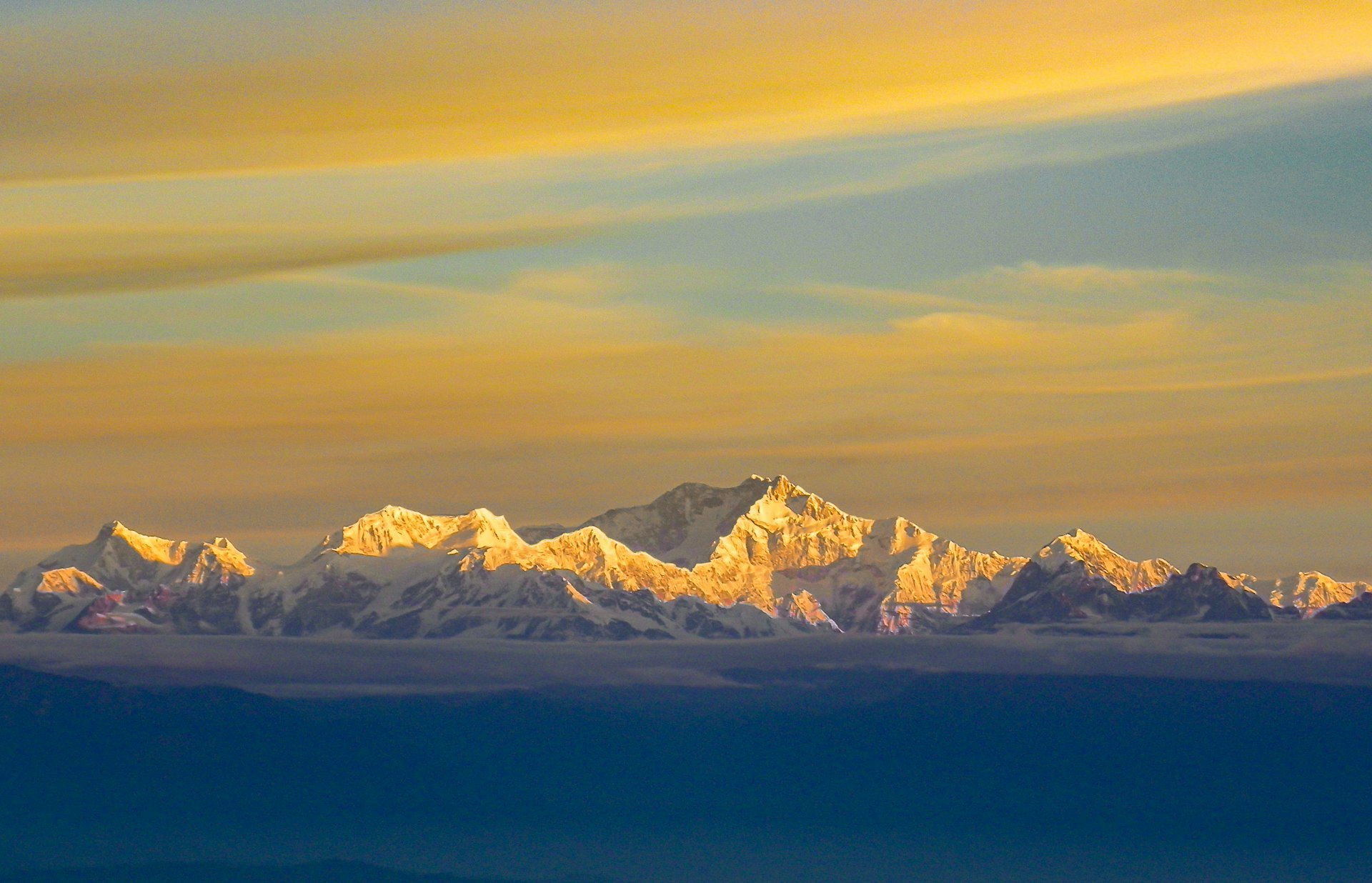 Snow mountain sunrise golden peaks India