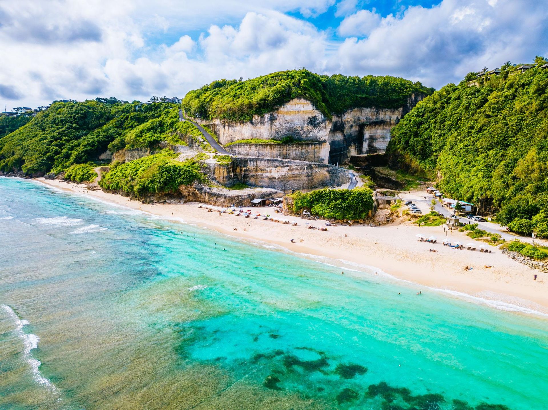 Hidden Bali beach with cliffs and blue water