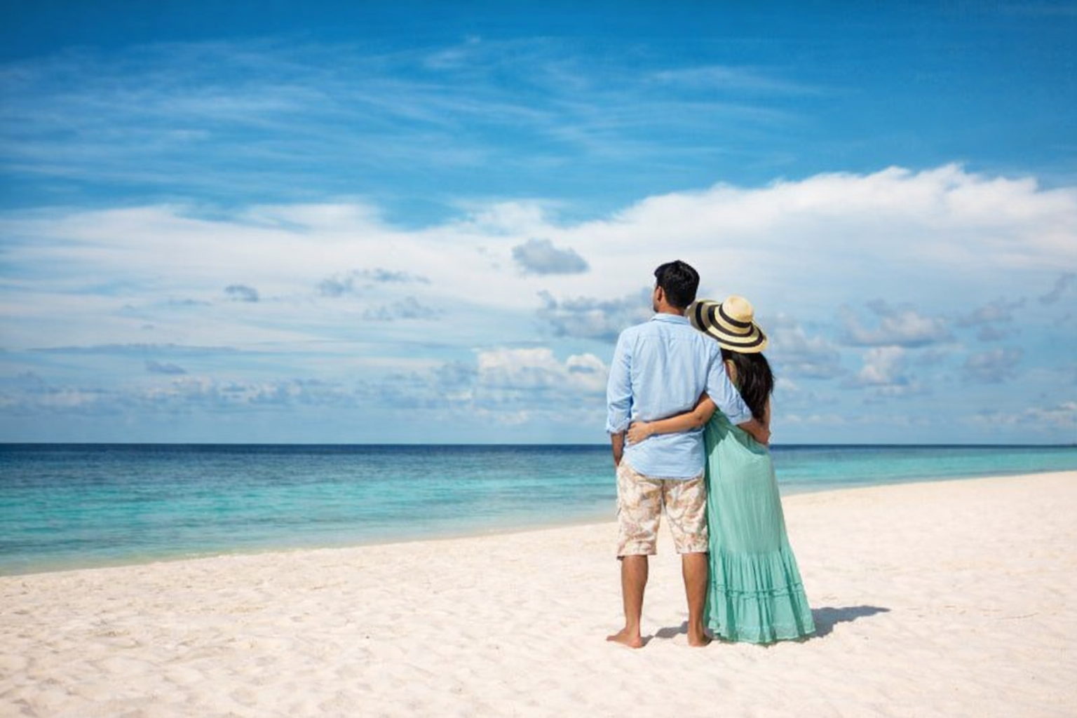 Couple walking on beach honeymoon destination tropical travel