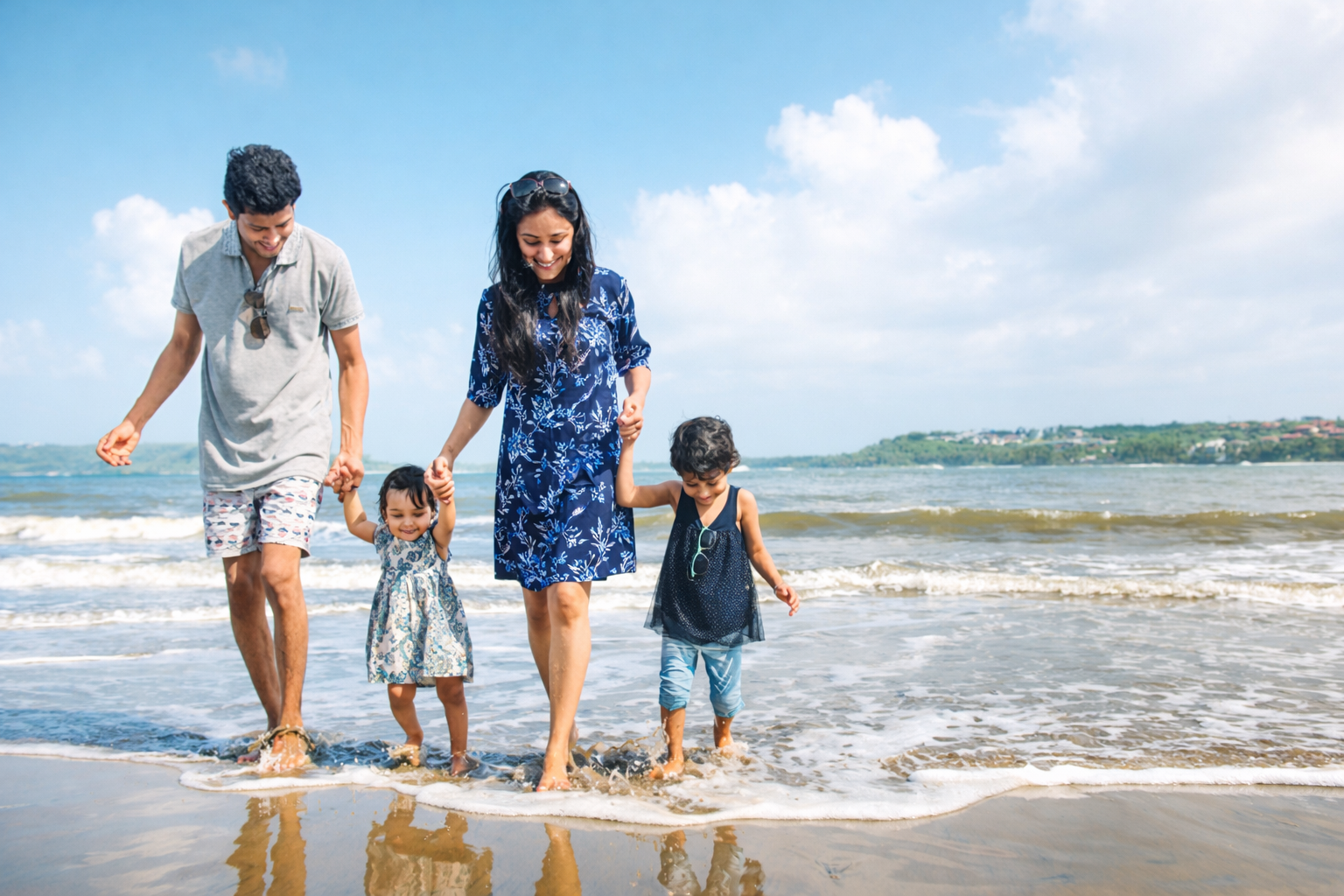 Family walking on beach vacation India