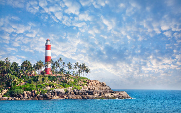 Lighthouse on rocky beach coastline India